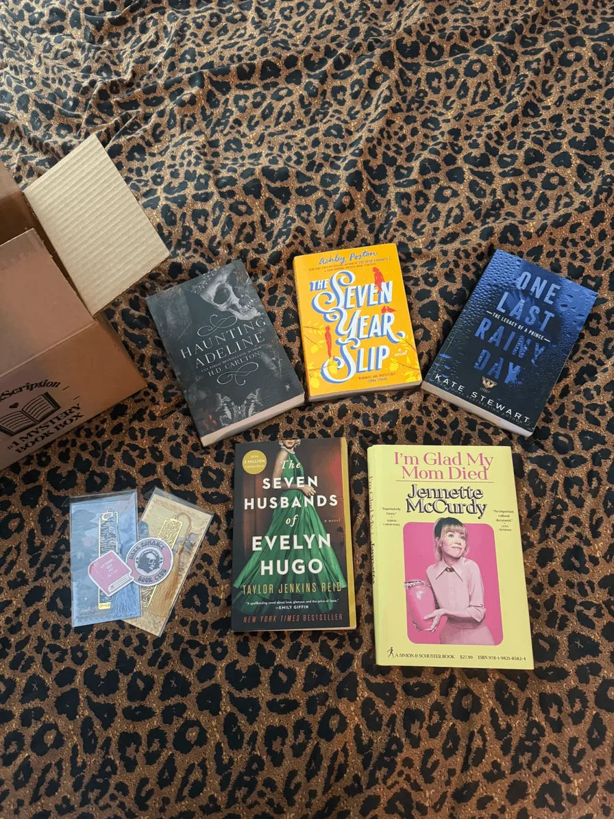 A reader holding books from their BookScription box
